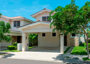 Outdoor covered patio area with hammock and lush green yard Bosques del Pacífico Panama Pacifico