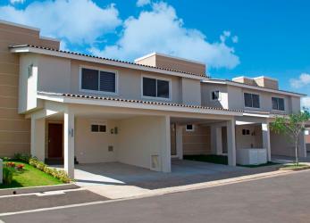 Contemporary bedroom with upholstered bed, natural light and decor in duplex house Panama Pacifico