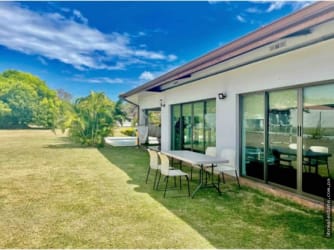 Bright open living and dining space with terrace access at Coronado beach house