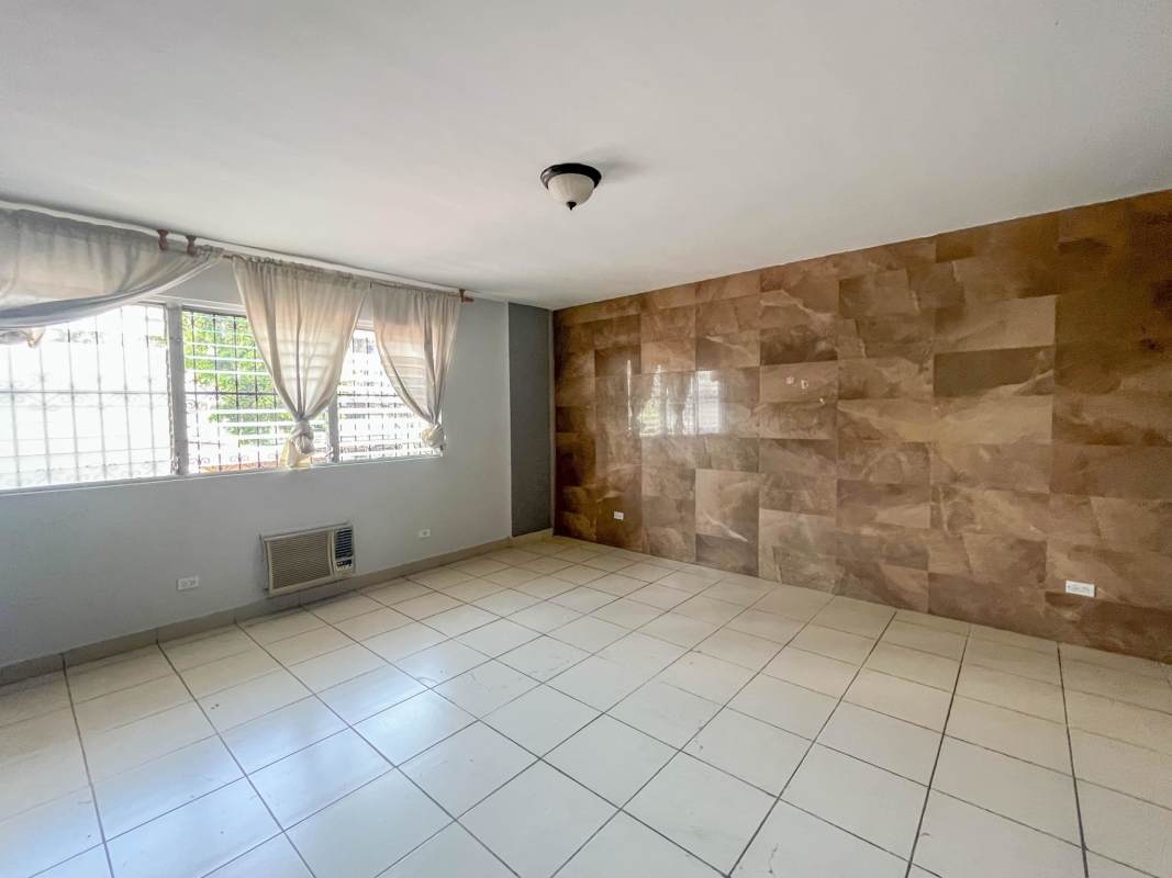 Living room with accent wall, tiled floor and large windows PH Aileen El Carmen Panama