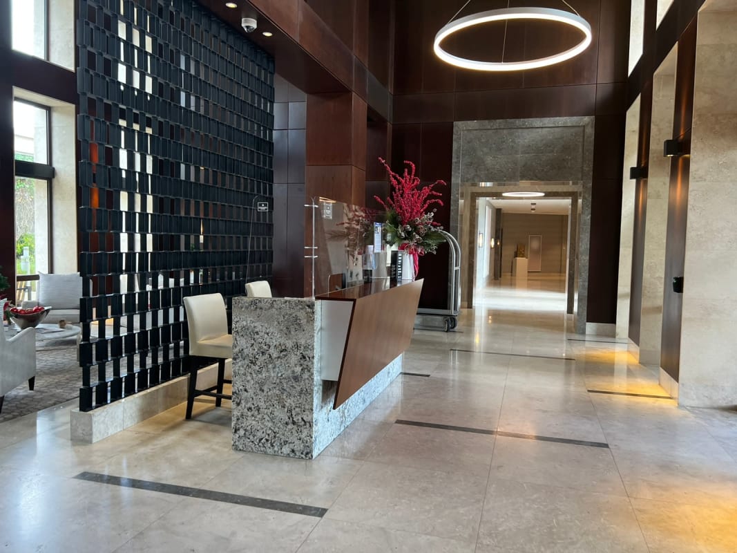 Elegant dining room with floor-to-ceiling windows, crystal chandelier, skylight, and Panama skyline views in Ocean Reef penthouse