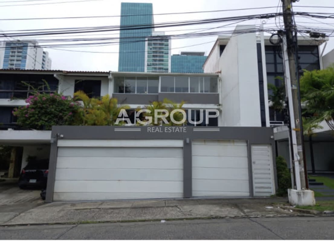 Modern double garage house front with tropical landscaping in Punta Paitilla Panama