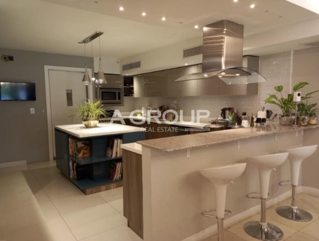 Spacious modern kitchen with granite island, stainless appliances, in Altos de Golf Panama City house