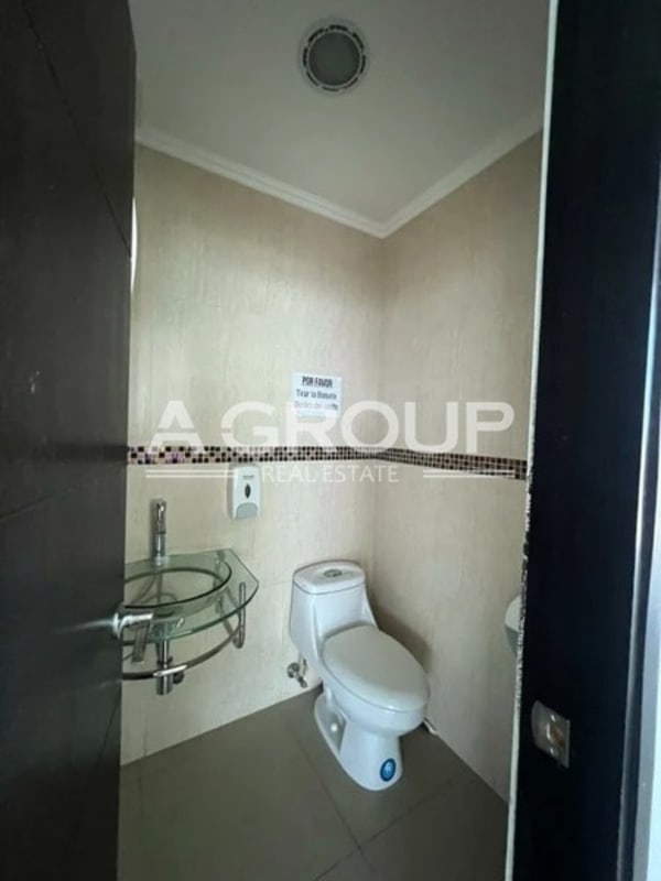 Bright office interior with panoramic glass walls overlooking Panama skyline in Revolution Tower