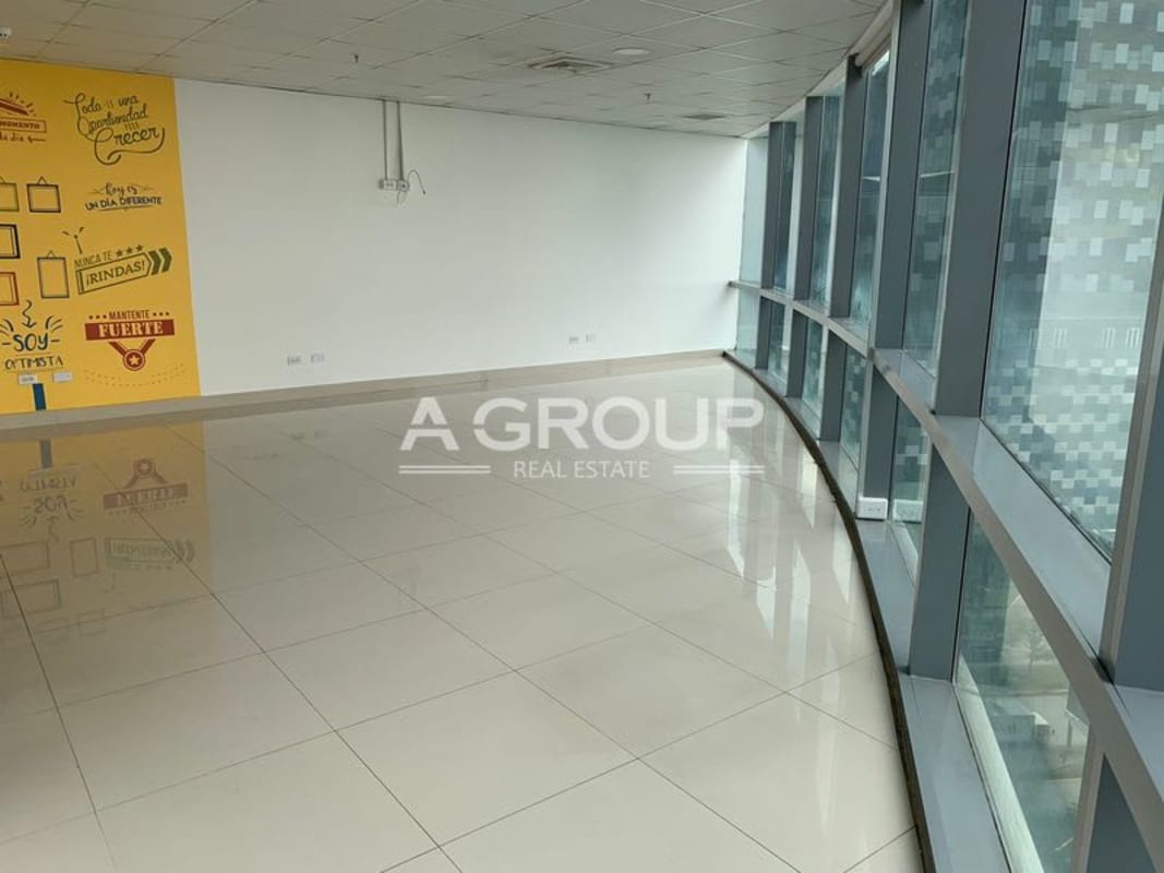 Spacious office interior with large windows floor-to-ceiling and wall with inspirational phrases at Financial Park
