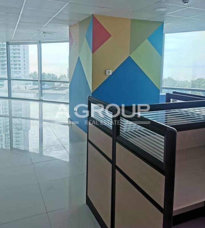 Open-plan office with motivational wall decor and tiled flooring at Financial Park Costa del Este