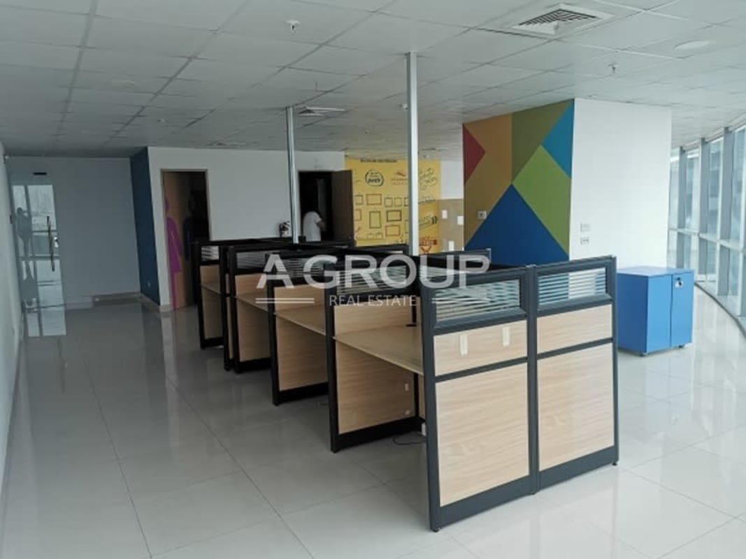 Bright office interior with full-length windows, cubicles, and city backdrop in Financial Park Panama