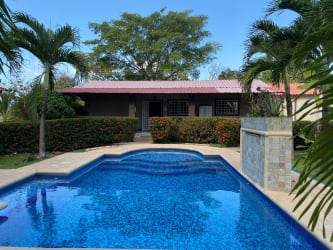 Spacious fenced yard with bohío gazebo, swimming pool and lush garden near San Carlos Panama