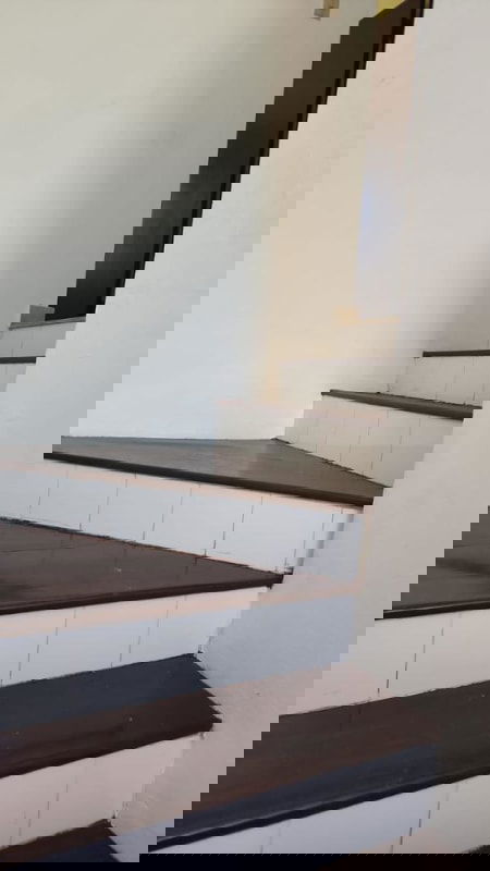 Large kitchen with white cabinets, granite countertop, double sink and security bars in Altos de Santa María home for sale