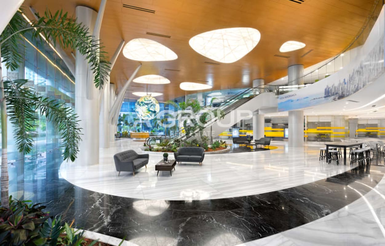 Spacious commercial lobby with large glass windows, escalator, seating area Financial Park Panama