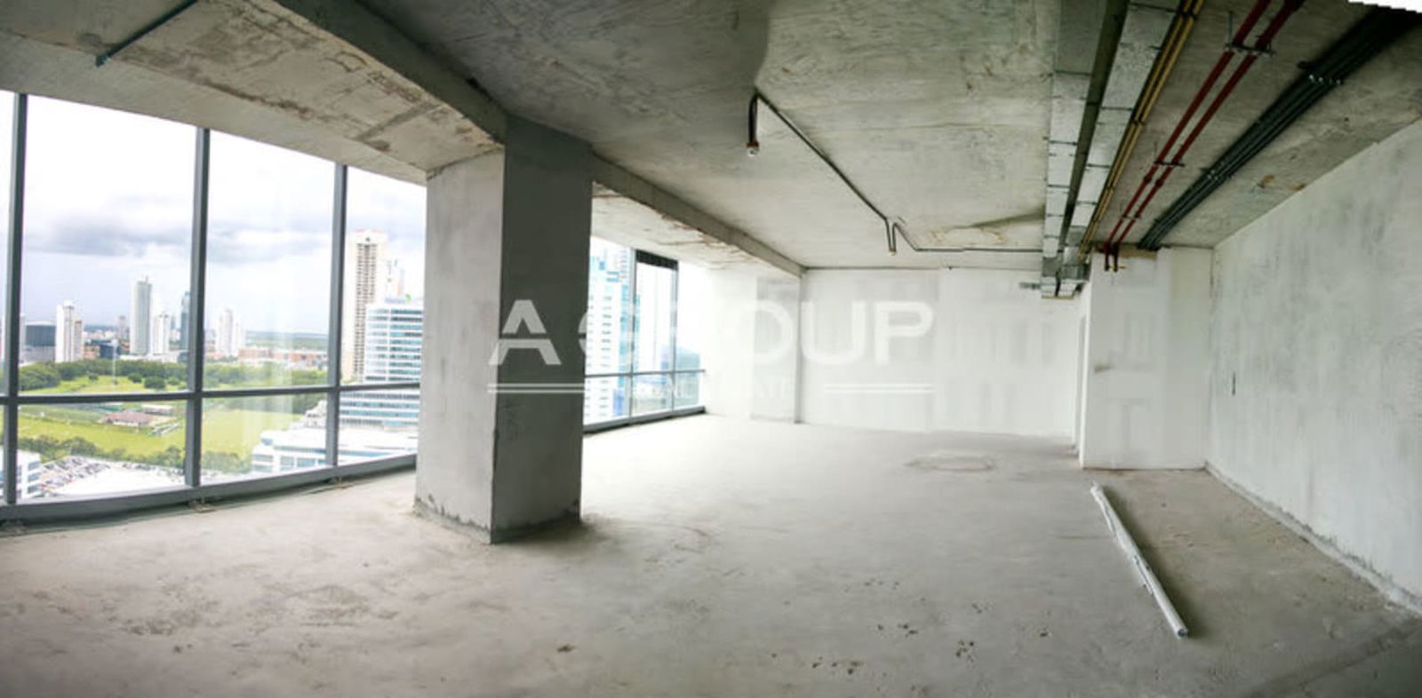 Industrial style open office space with large windows in Costa del Este tower