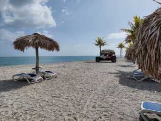 Open plan living dining room luxury seaside condo PH Waterways Playa Blanca with panoramic windows