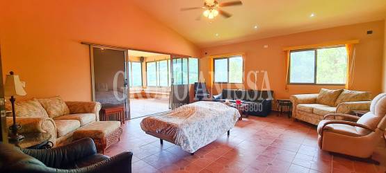 Living area with tile flooring and ceiling fans in mountain home Panama