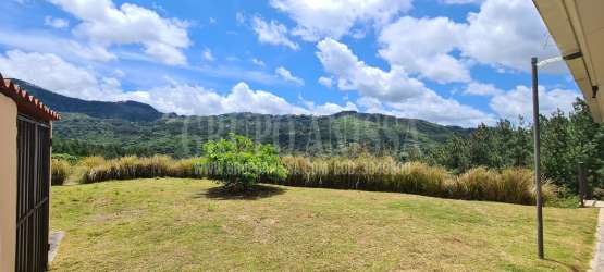 Dining space with windows overlooking mountain landscape in Altos del María Panama