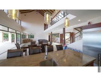 Infinity pool with panoramic rainforest and ocean views overlooking Panama Oeste estate