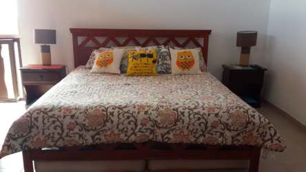 Spacious master bedroom king bed wood decor in Las Uvas beach house for rent San Carlos Panama