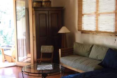 Living room with wood floors, large windows, open door to garden Azueros Pedasi Panama
