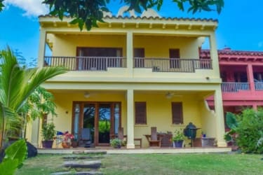 Balcony with wooden bench and chairs overlooking tropical greenery in Azueros Pedasi Panama