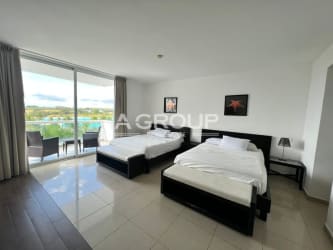 Bright modern studio with beds, flat TV, full mirror and balcony overlooking pool at Playa Blanca