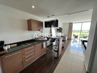 Compact kitchenette in studio apartment with microwave, mini fridge, granite counters at Playa Blanca Panama