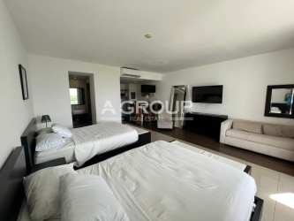 Private balcony with outdoor furniture overlooking lagoon and gardens in Playa Blanca Resort Panama