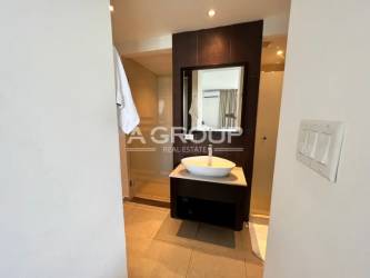 Aerial panoramic of giant lagoon pool surrounded by palm trees in Resort Town Center Playa Blanca