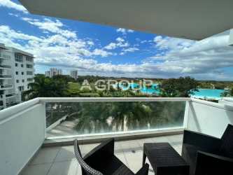 Modern beachfront condo complex with pool, gardens and palm trees at Playa Blanca Town Center