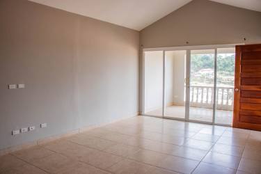 Bright living room with balcony door and large windows in The Hill Top Arraiján Panama