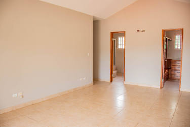 Kitchen with granite countertops, wood cabinets, large window in The Hill Top Arraiján Panama