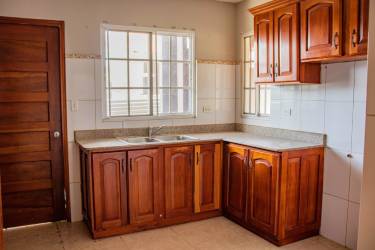 Traditional kitchen with wooden cabinets and granite counters in The Hill Top Residential Panama