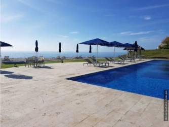 Bedroom with ocean view window in PH Perlamar Casamar Resort Panama