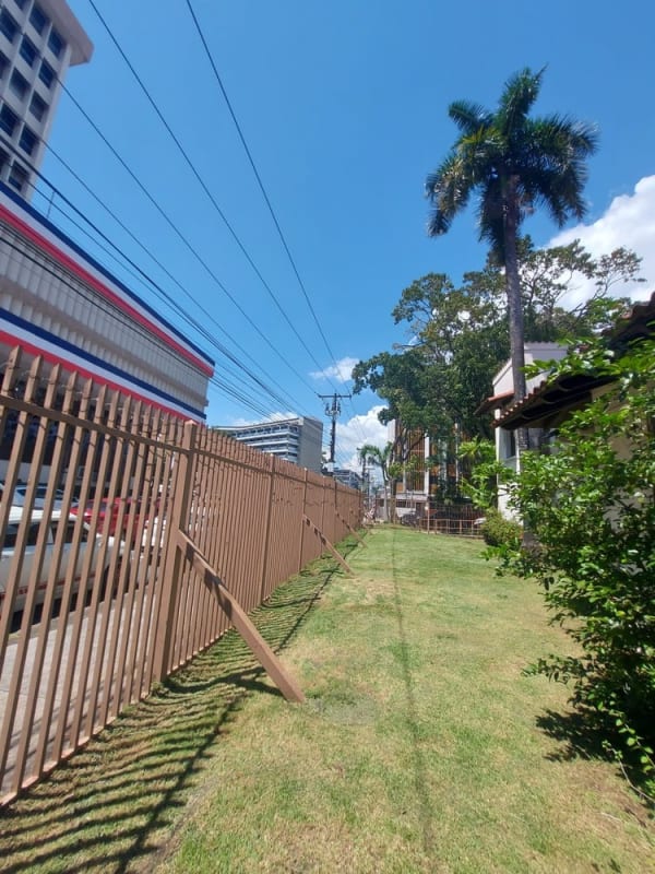 White stucco facade, arches, terracotta tile roof and palm garden historic Panama City property