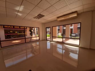 Outdoor common area with seating and decorative plants at The Village Mall Panama