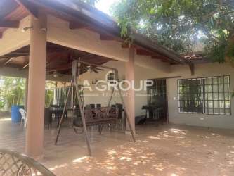 Rustic covered patio area with dining set and swing at Coronado beach house Panama