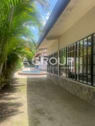Tropical-style house with pool surrounded by palm trees and garden in Coronado beach area