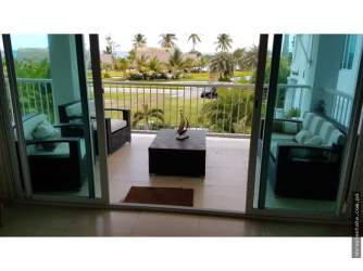 Bedroom with sliding door to balcony, garden and palm views at Bijao Beach Panama