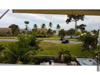 Modern tiled balcony with outdoor seating and ocean view in Bijao Panama