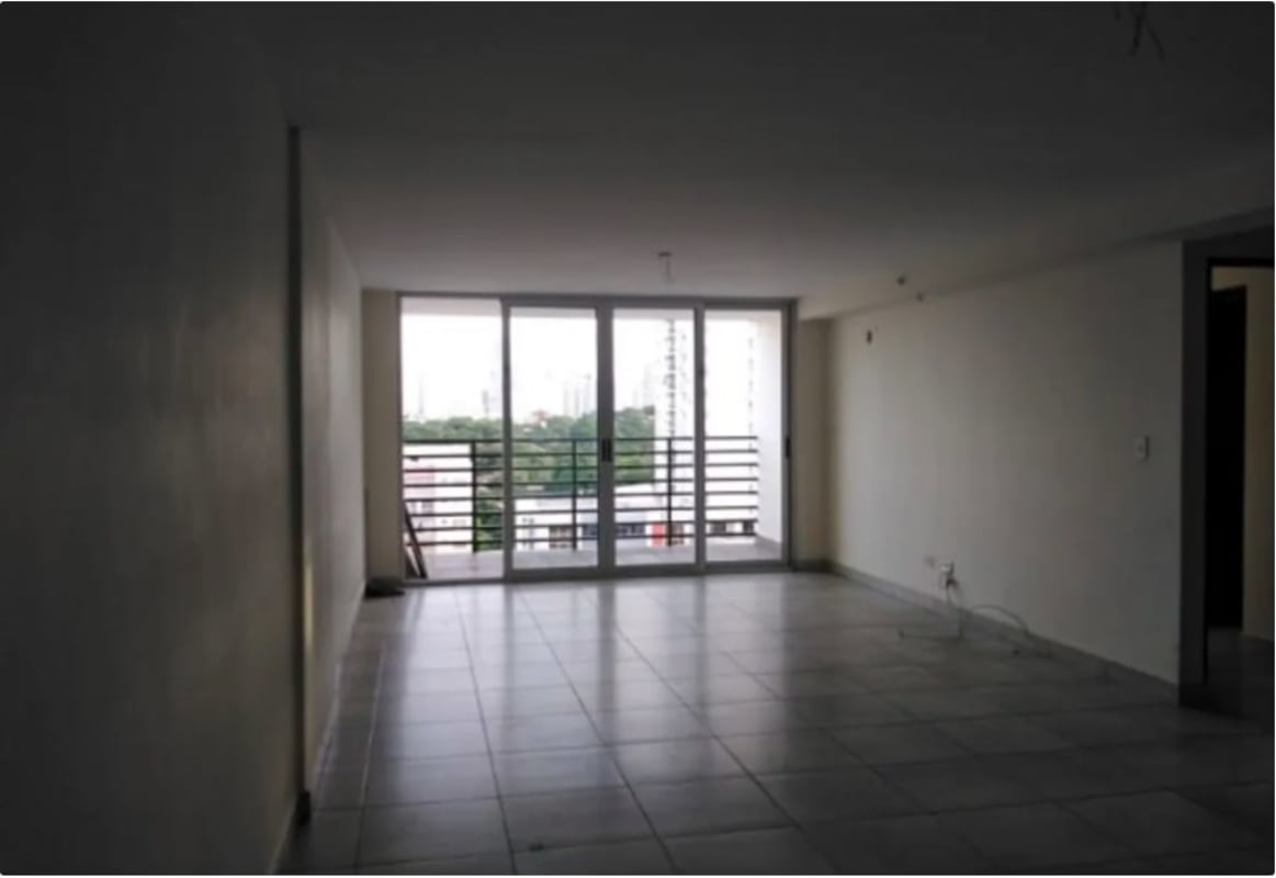 Spacious living room with large window and balcony view at PH Parque Lefevre Panama