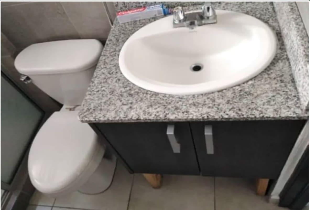 Laundry room with concrete sink and tiled walls in PH Parque Lefevre Panama City apartment