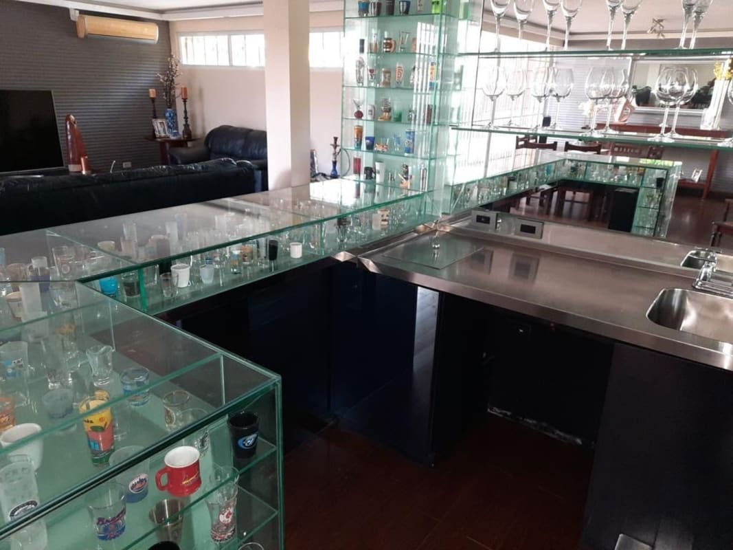 Modern bathroom with vessel sink glass and wood finishes in house for sale La Alameda Panama