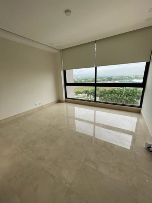 Wide balcony with marble flooring, glass railing featuring golf course lake and Panama skyline views
