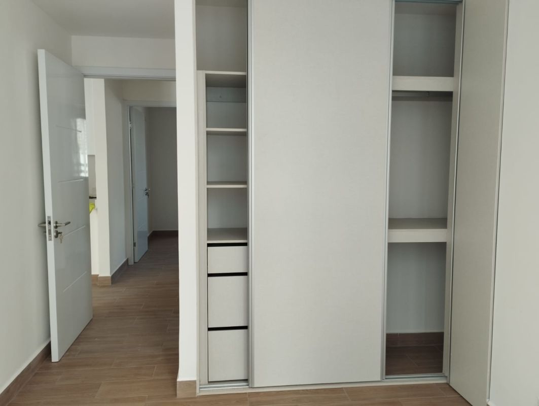 Bedroom featuring built-in closet and tile floors in PH Sky Swiss Panama City