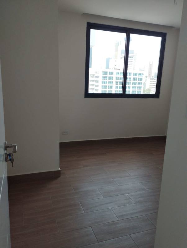 Bright bedroom with large city view windows in PH Sky Swiss El Cangrejo Panama