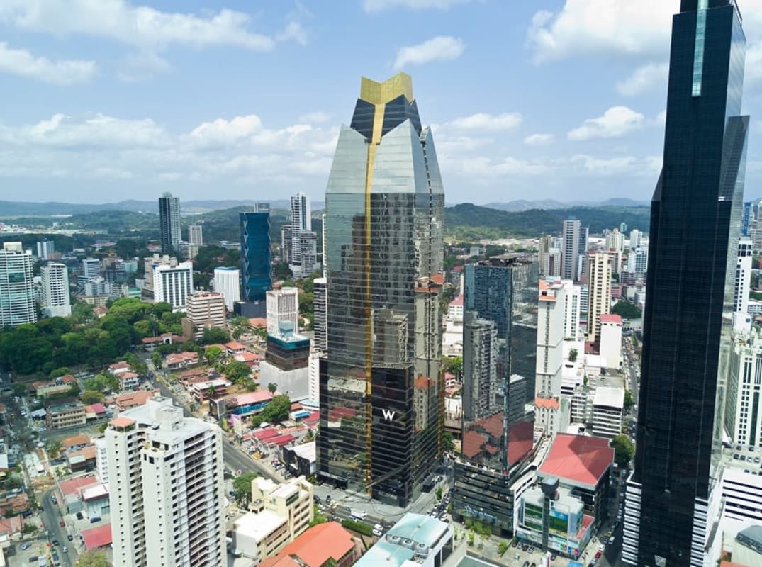 Spacious unfinished commercial floor with large glass windows overlooking Panama City in Evolution Tower
