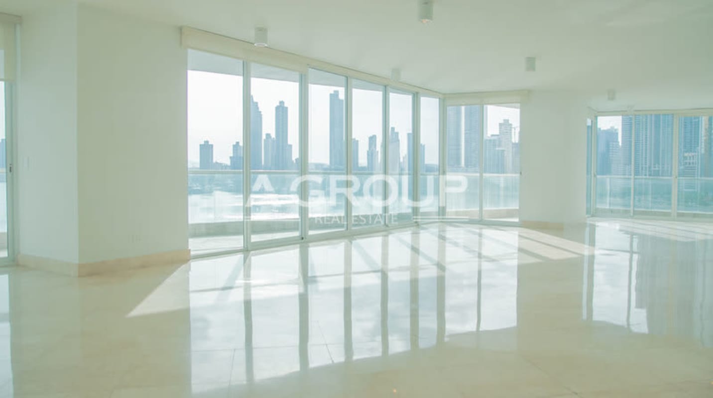 Open plan luxury living room with marble floors panoramic ocean windows in The Point Punta Paitilla Panama