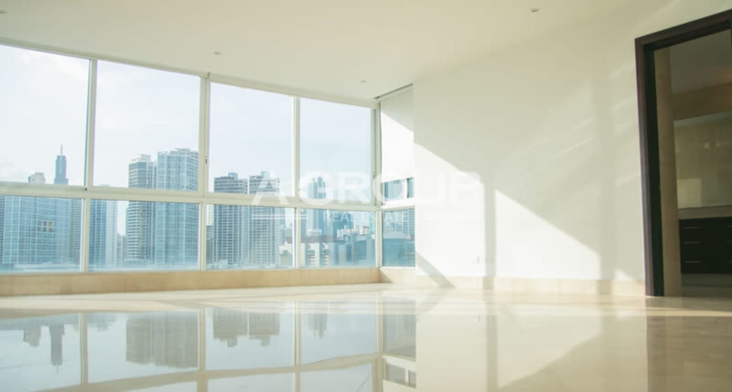 Empty living room with marble floors skyline window views The Point Tower Panama