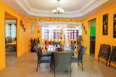 Traditional kitchen with wooden cabinets, tile countertops, stainless appliances in mountain home Panama