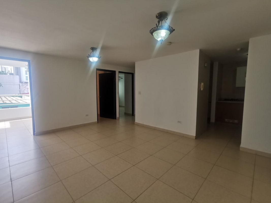 Compact kitchen with stove, upper cabinets, sink and window at PH HIP Tower Panama