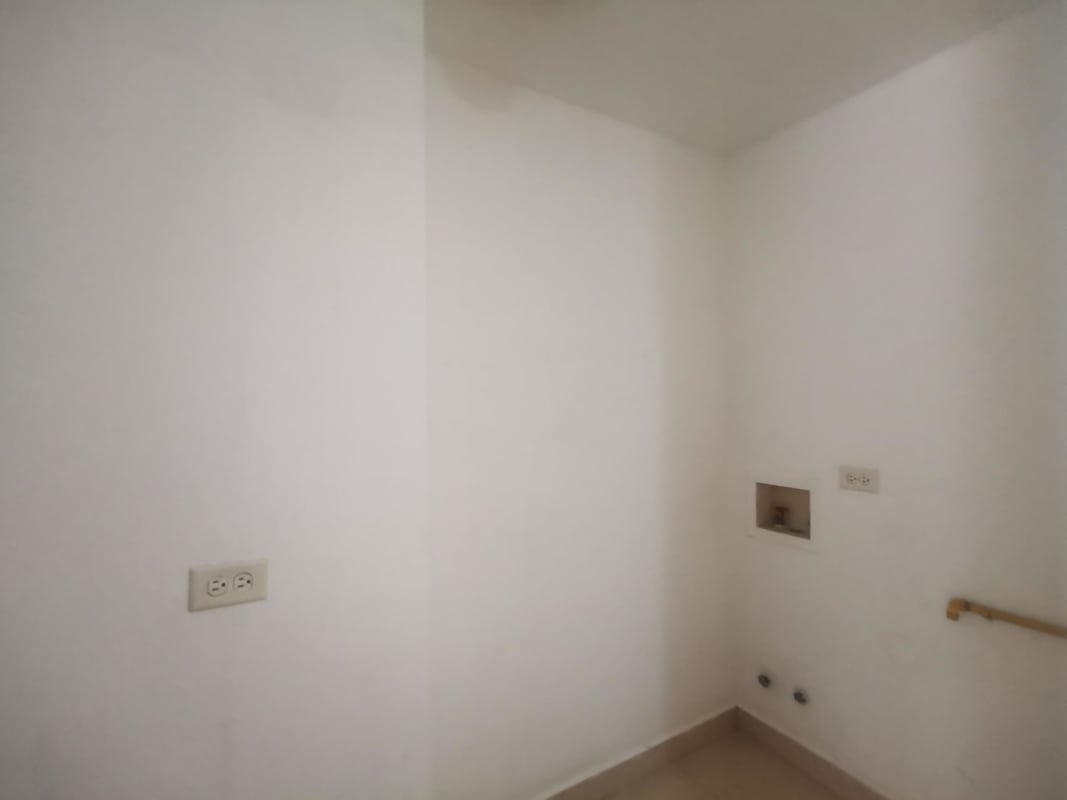 Laundry area with tiles, utility sink, plumbing connections at HIP Tower Panama City condo