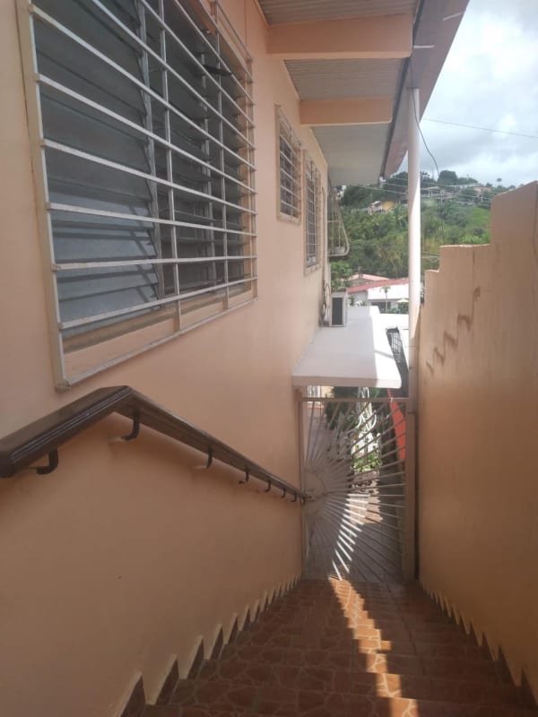 External staircase with tiled steps and secure window grills at family house Altos de Panamá Panama